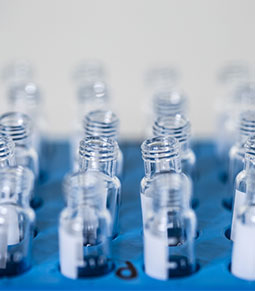 A photo of open empty sample vials in a rack