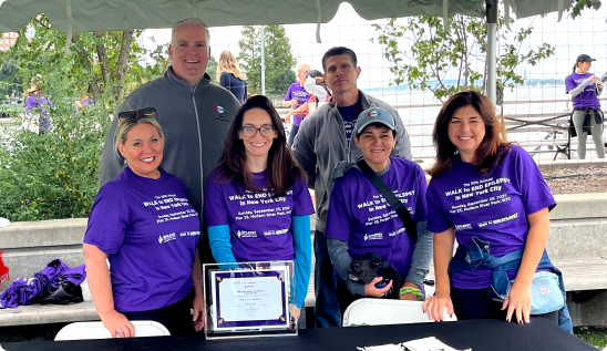 A group of Eisai employees gathered at a community engagement booth