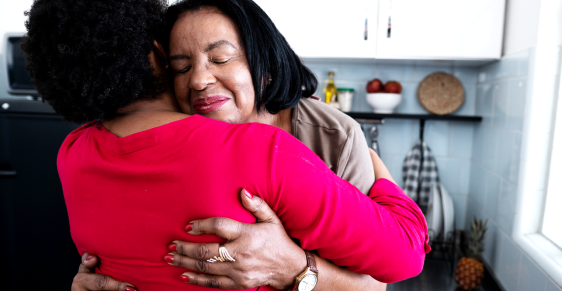 Two women hugging one another