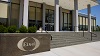 An outdoor view of an Eisai corporate building entrance with Eisai logo.