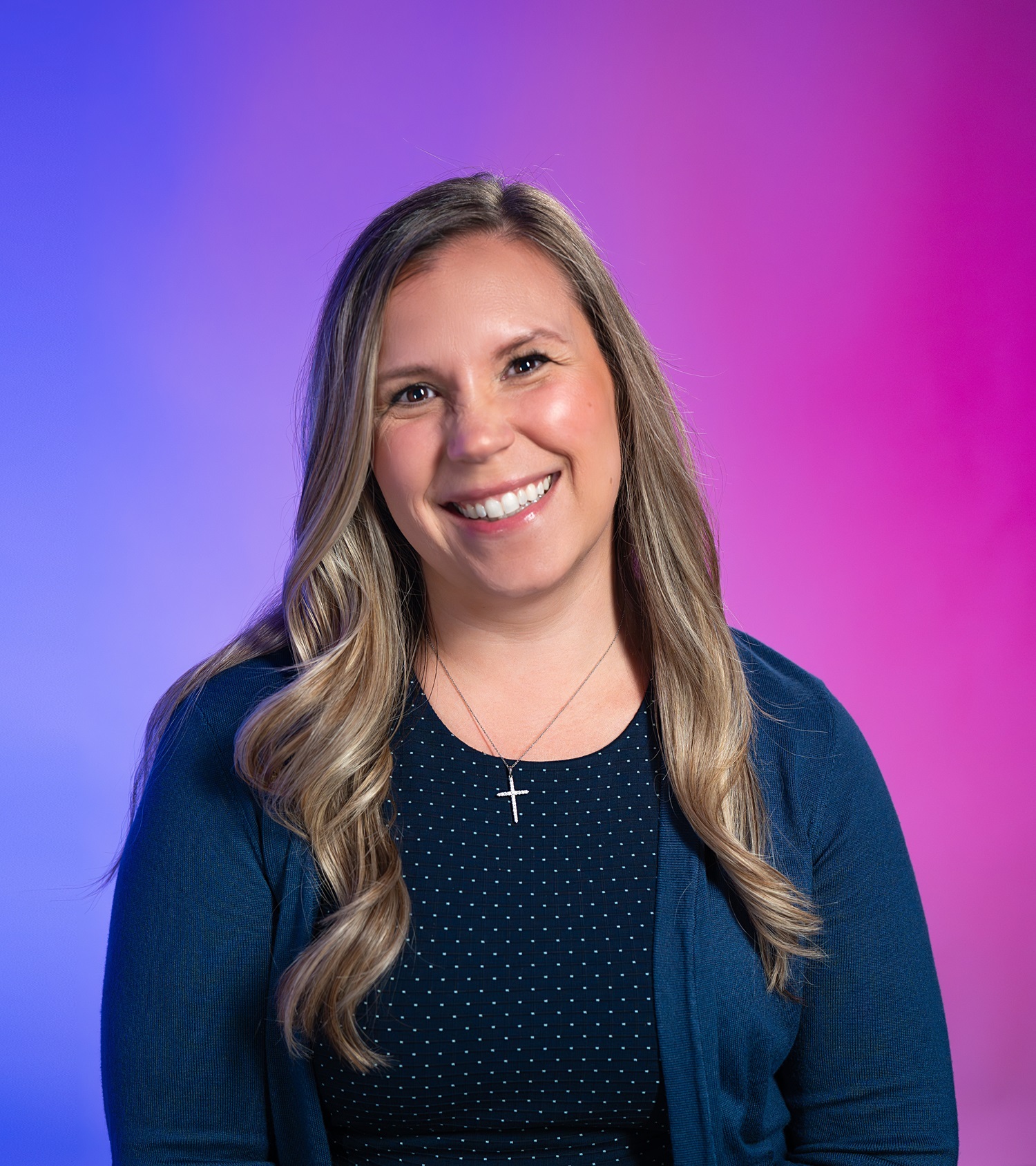 Headshot of Laura Fenn in front of a blue and pink gradient background.
