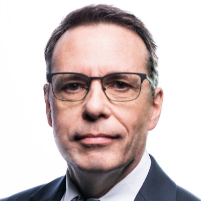 Headshot of Laura Fenn in front of a blue and pink gradient background.