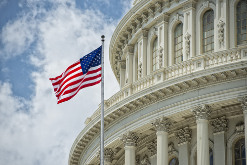 A United States flag pole in front of a building